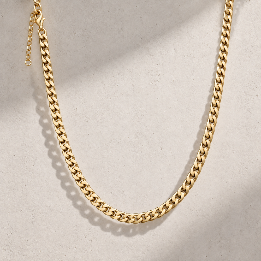 Icon Cuban Chain in Gold displayed against a stone surface