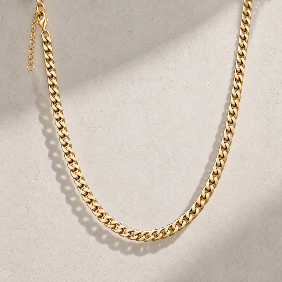 Icon Cuban Chain in Gold displayed against a stone surface