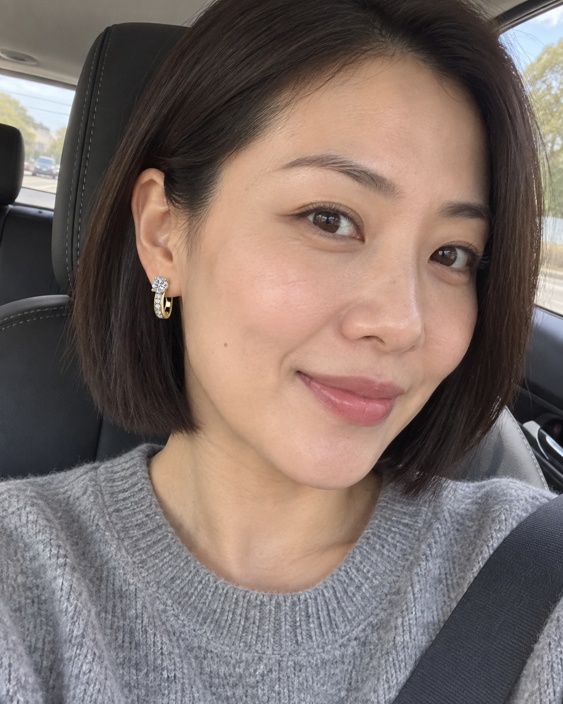 Customer-style photo wearing Channel Huggie Earrings