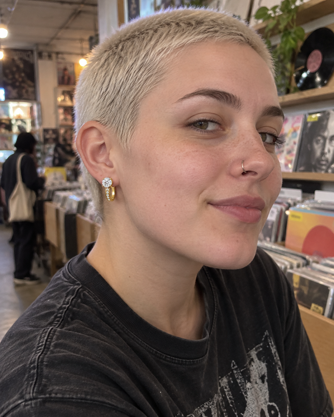 Customer-style photo wearing Channel Huggie Earrings